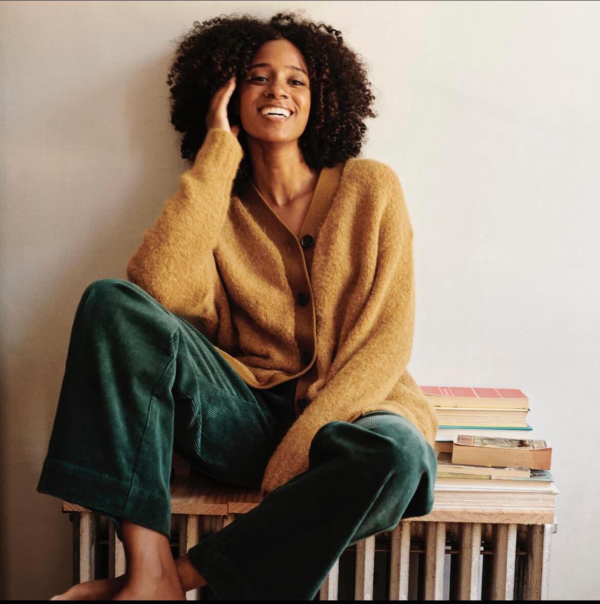 Beautiful black woman with curly hairstyle in a casual sweater