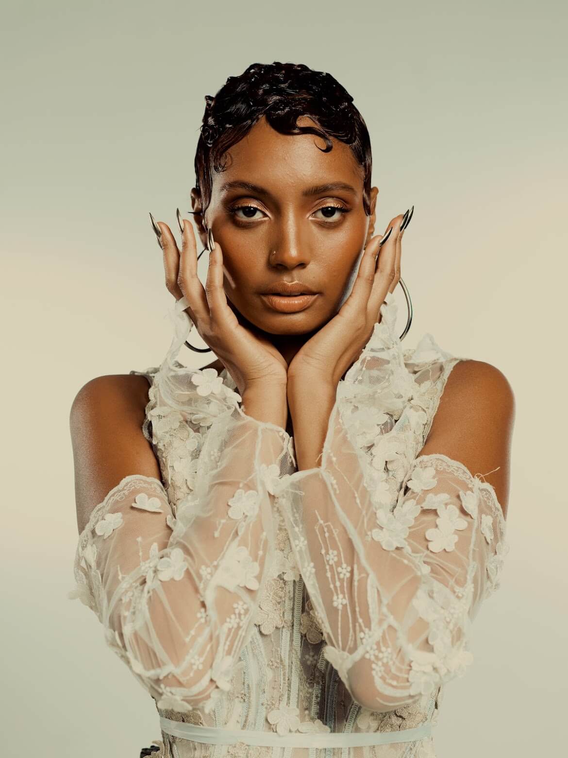 Beautiful black woman with chic, short hair style and white lace dress