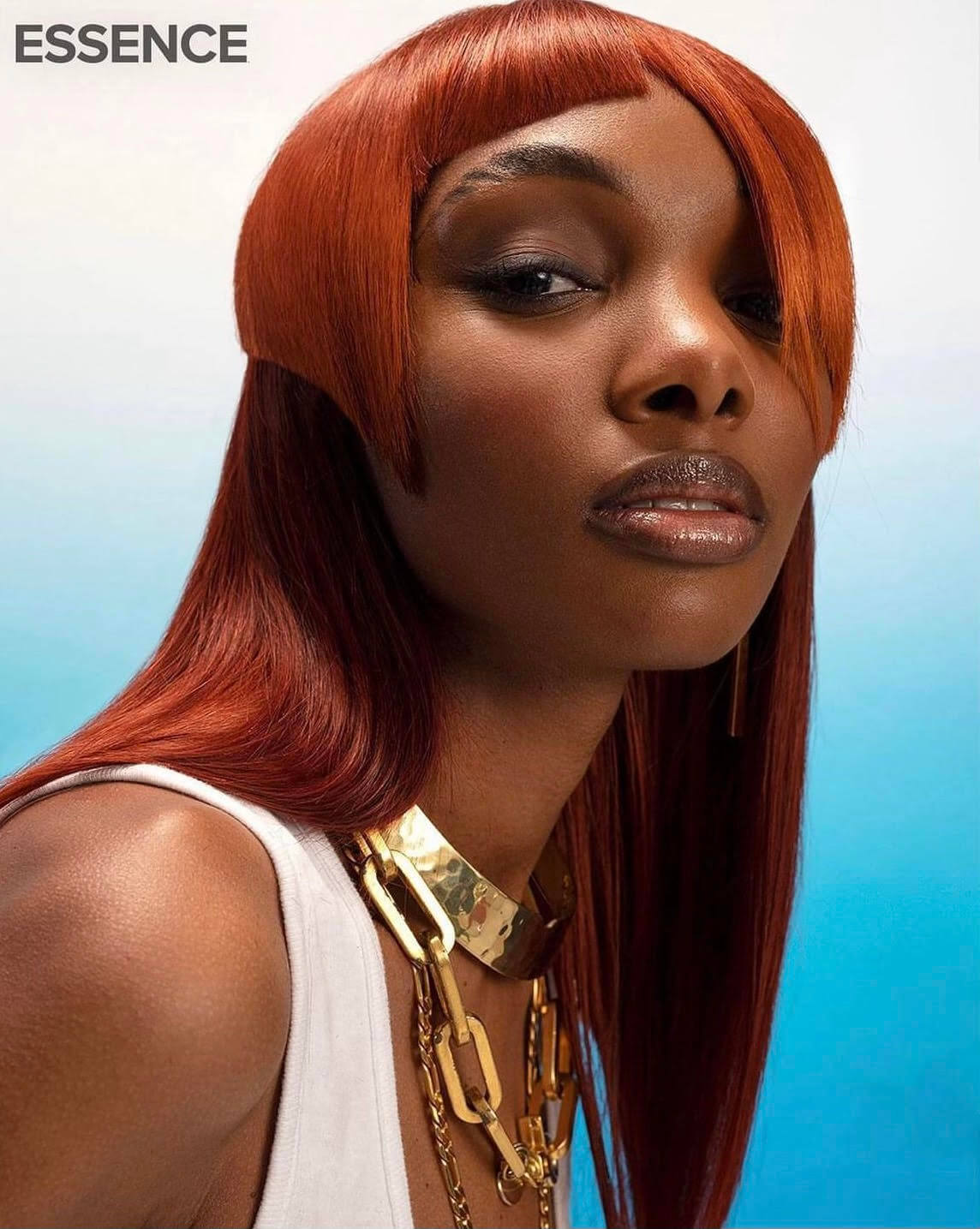 Beautiful black woman with trendy red haircut and gold necklaces